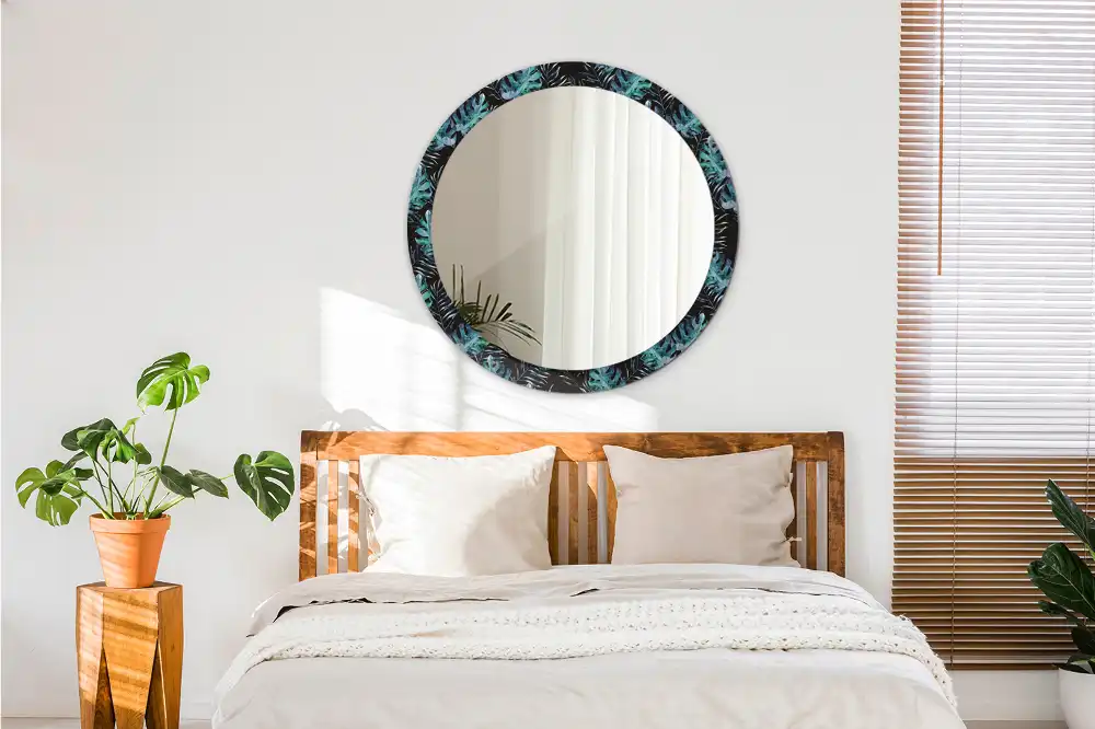 Miroir rond avec décoration feuilles exotiques