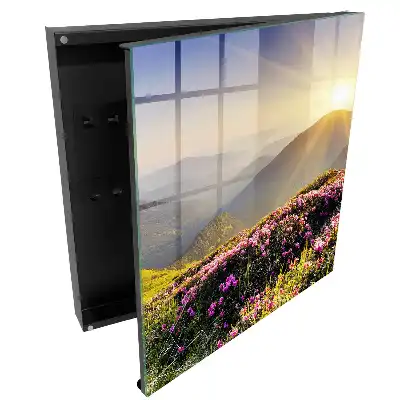 Boîte à clés montagnes et fleurs roses au lever du soleil