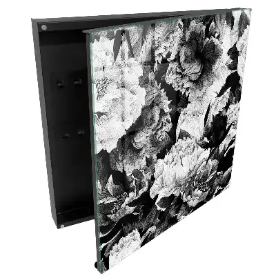 Boîte à clés des fleurs dans l'élégance du noir et blanc en harmonie.