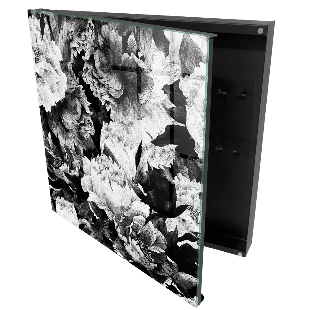 Boîte à clés des fleurs dans l'élégance du noir et blanc en harmonie.