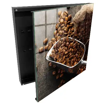 Boîte à clés grains de café bruns dans une louche en métal