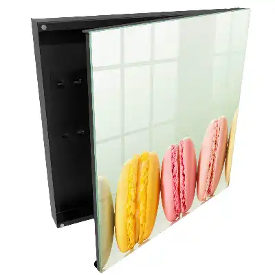 Boîte à clés macarons colorés alignés sur un fond pastel