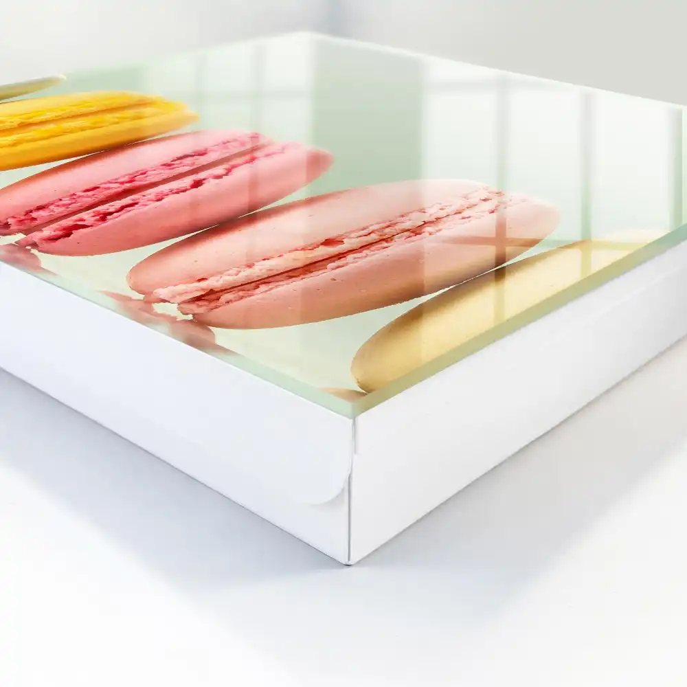 Boîte à clés macarons colorés alignés sur un fond pastel