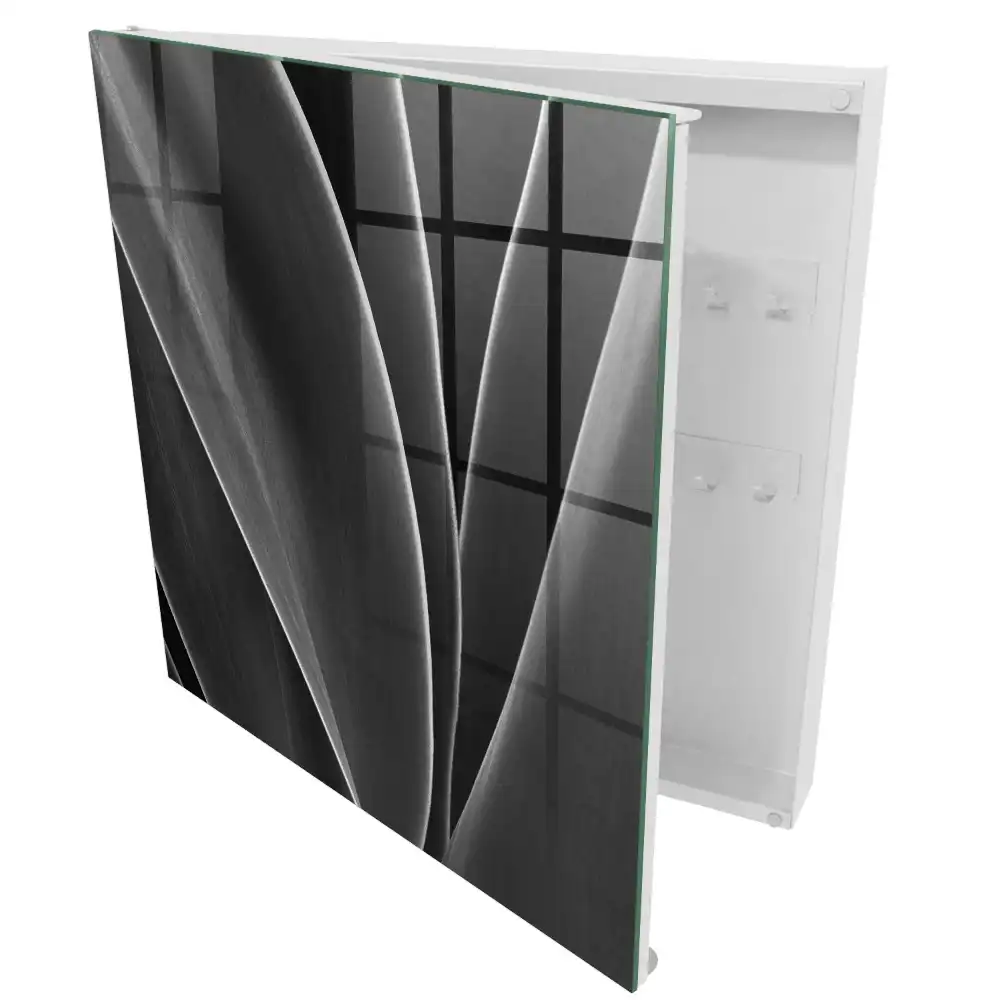 Armoire à clés feuilles noires et blanches dans une composition élégante