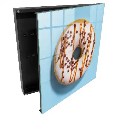 Armoire à clés beignet avec glaçage et vermicelles sur fond bleu
