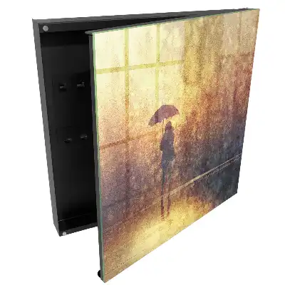Boîte à clés une personne avec un parapluie dans la lumière du coucher de soleil