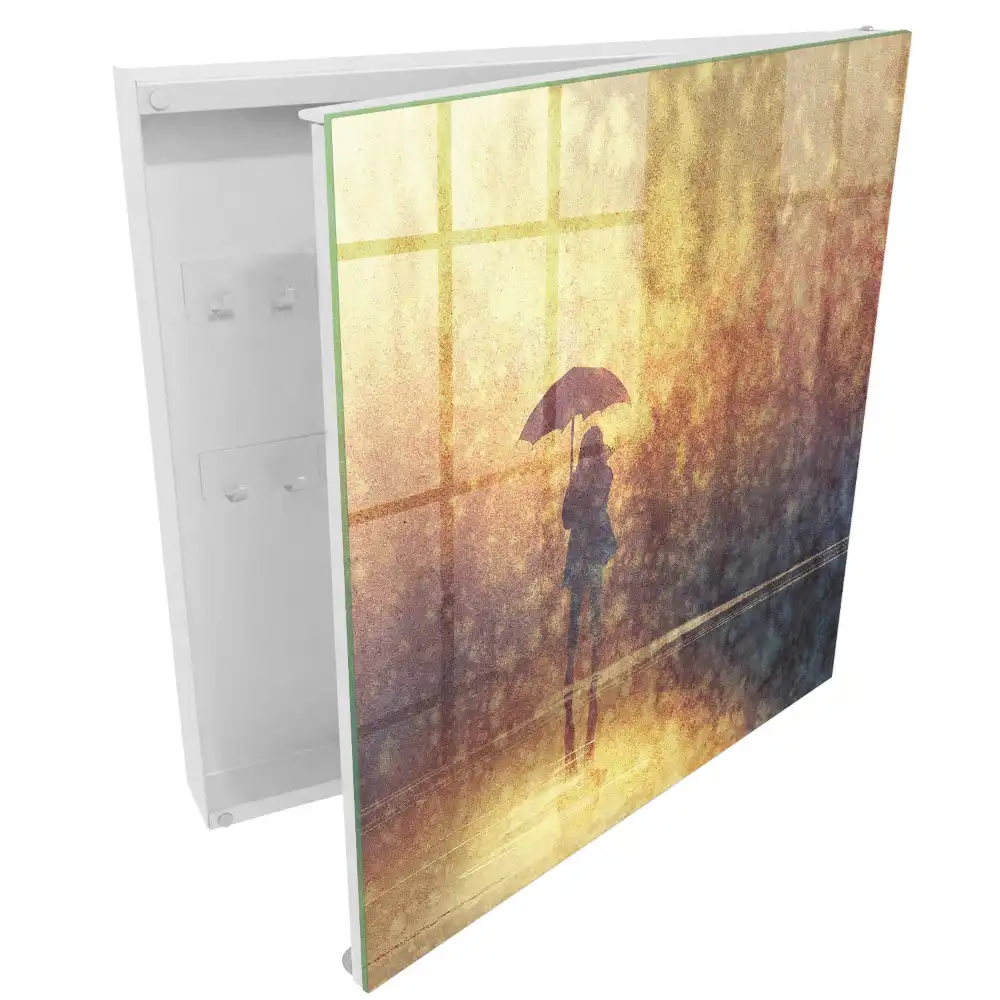 Boîte à clés une personne avec un parapluie dans la lumière du coucher de soleil