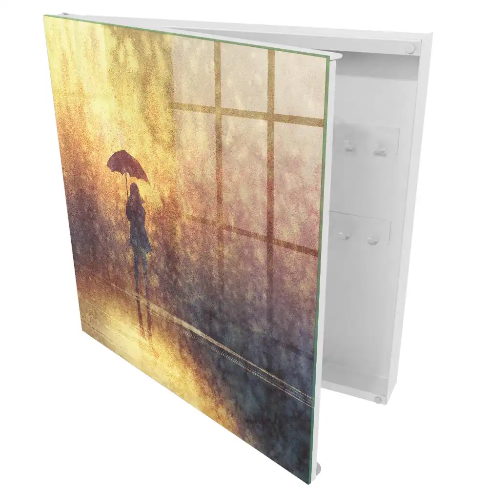Boîte à clés une personne avec un parapluie dans la lumière du coucher de soleil