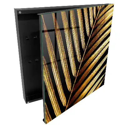 Armoire à clés feuilles dorées sur fond noir