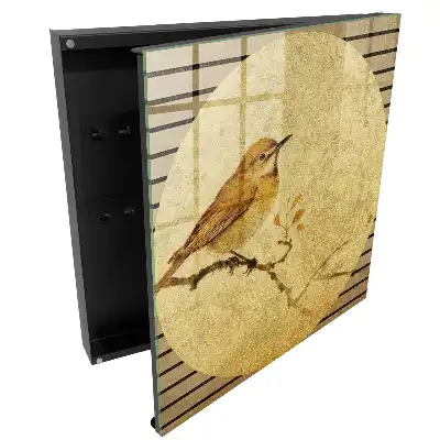 Armoire à clés un oiseau couleur crème sur une branche