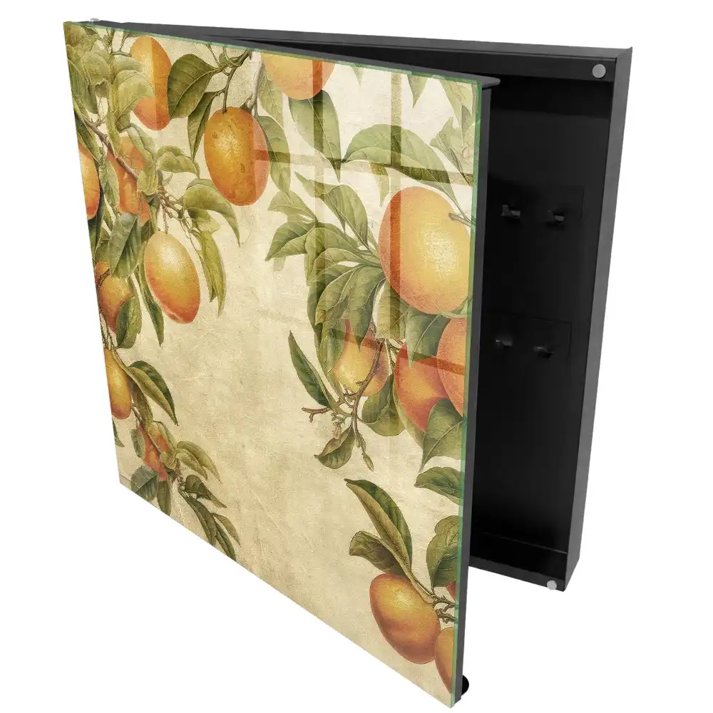 Boîte à clés orange parmi les feuilles sur fond clair