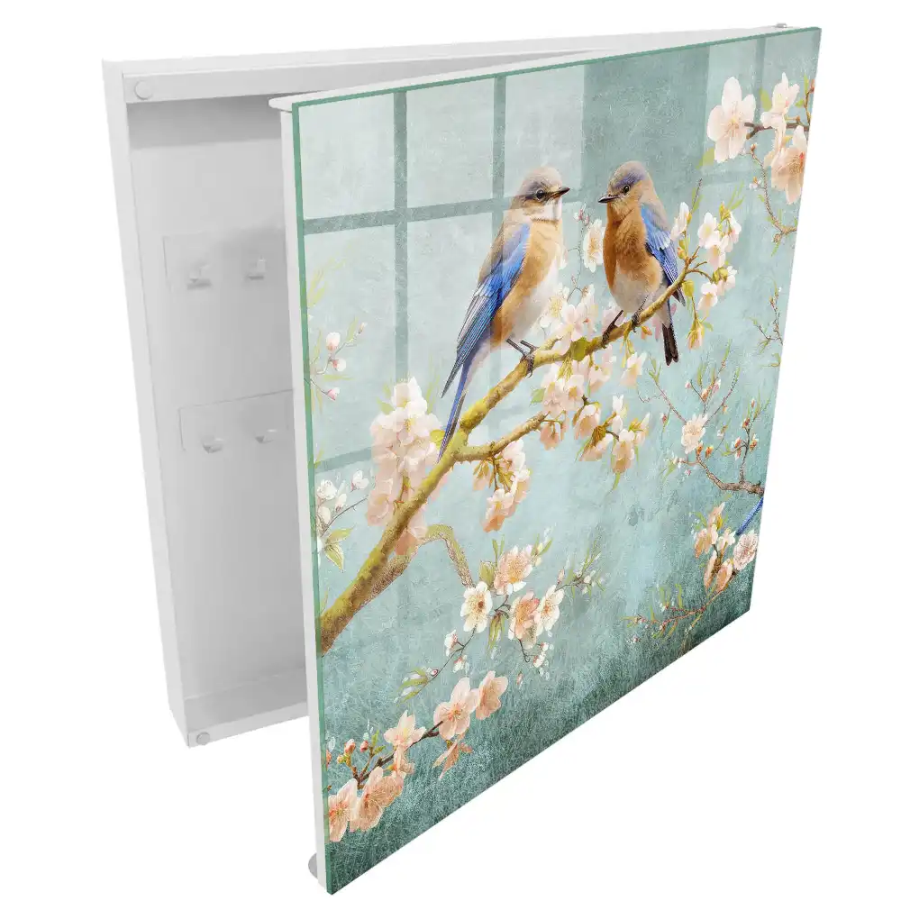 Armoire à clés oiseaux pastel sur une branche parmi les fleurs