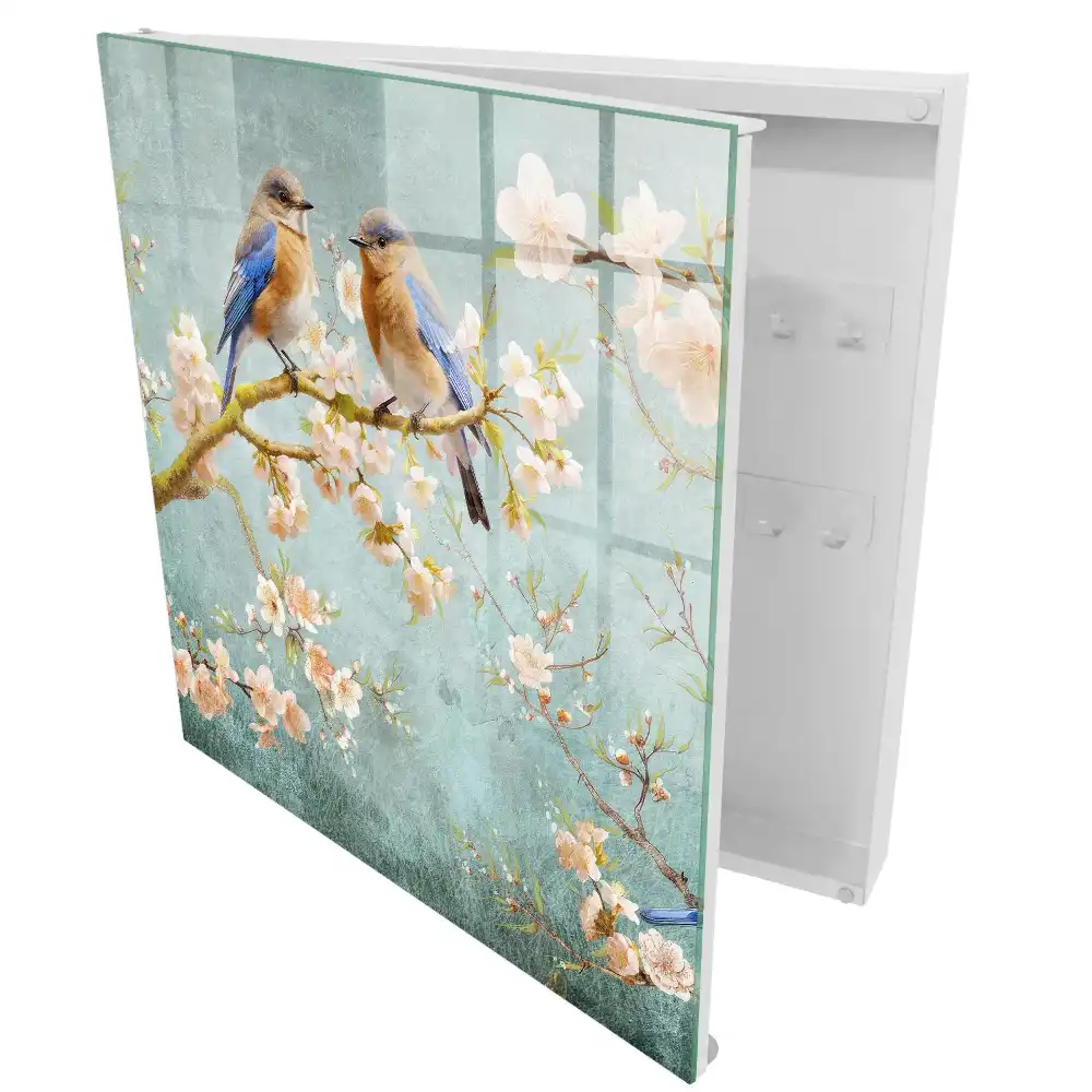 Armoire à clés oiseaux pastel sur une branche parmi les fleurs