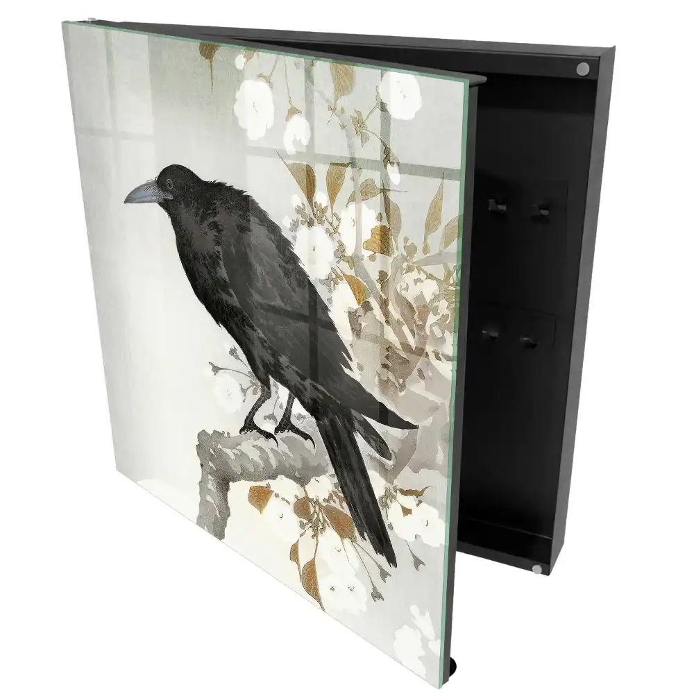 Armoire à clés un corbeau se détachant sur une branche fleurie