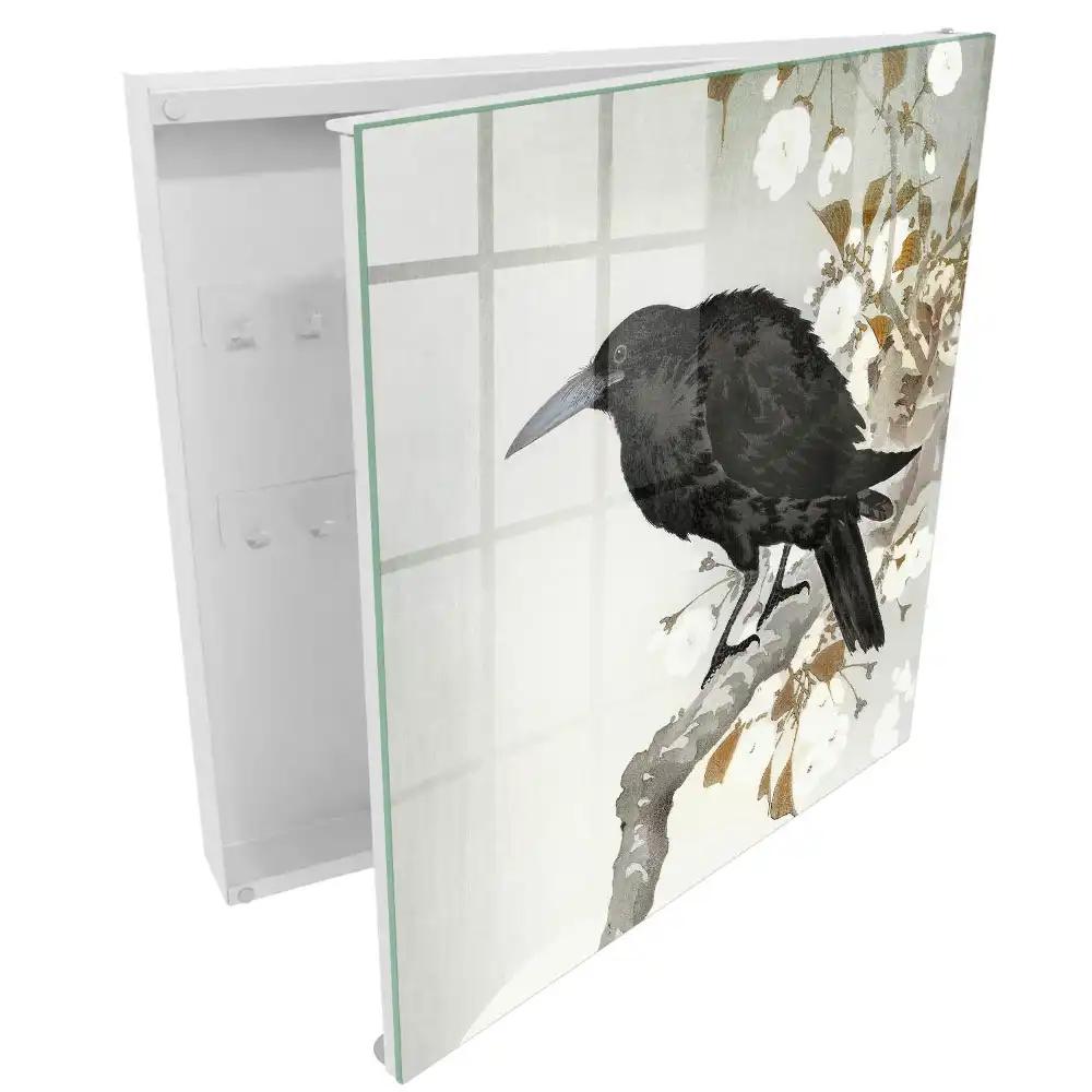 Armoire à clés un corbeau se détachant sur une branche fleurie