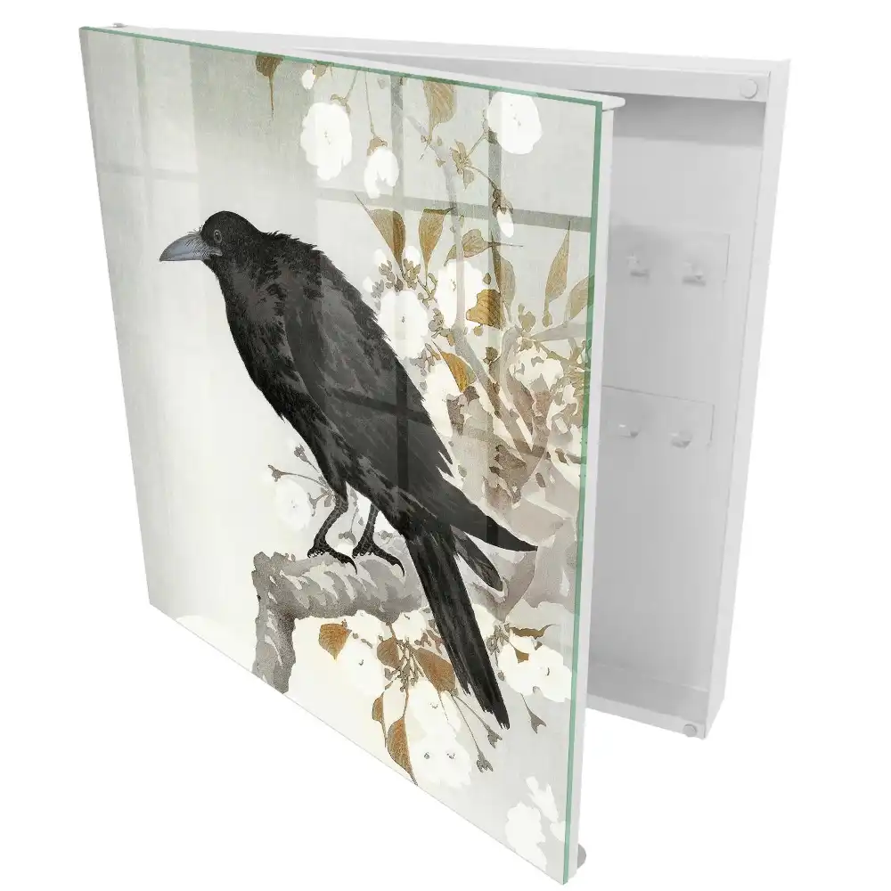 Armoire à clés un corbeau se détachant sur une branche fleurie