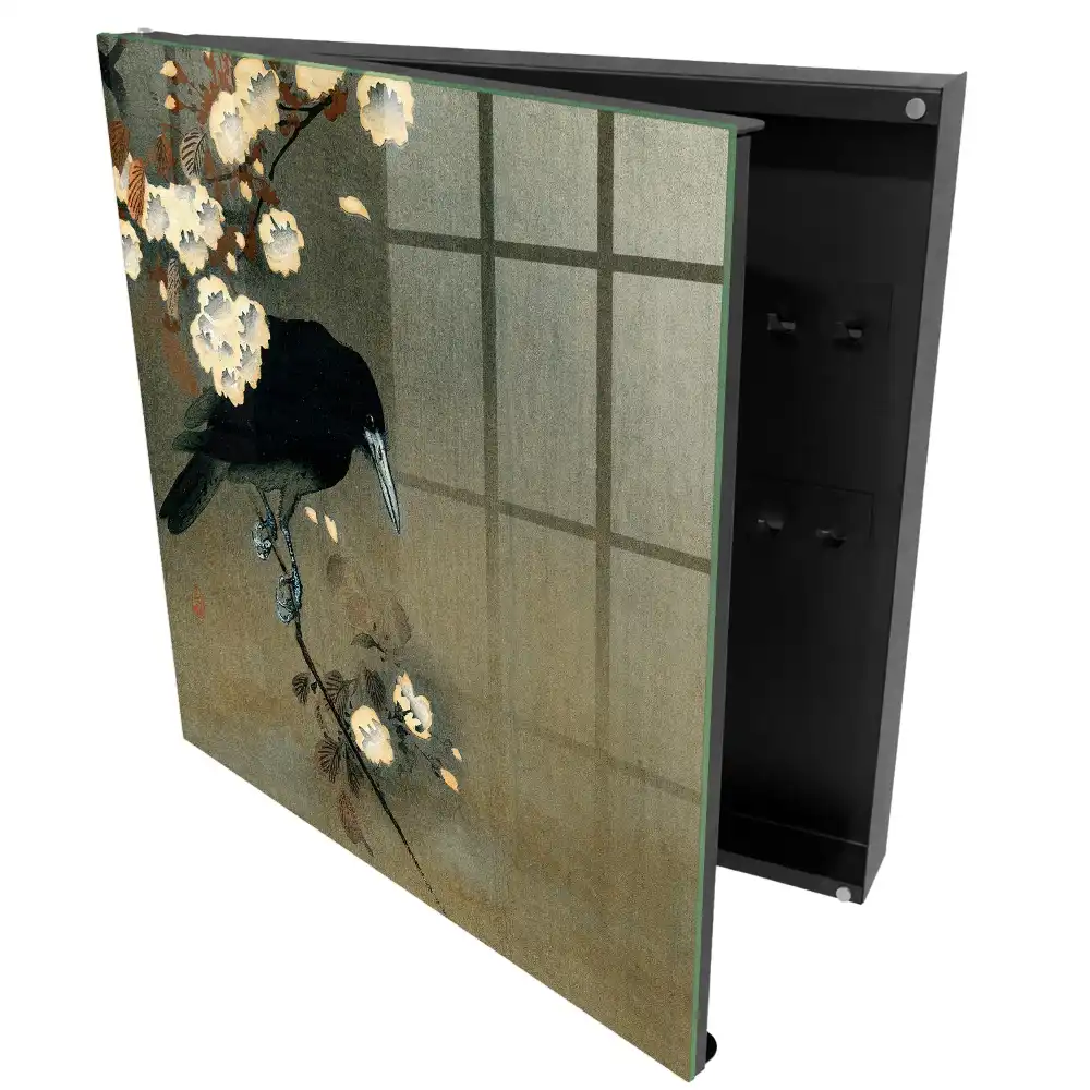 Armoire à clés un corbeau sur une branche avec des fleurs blanches