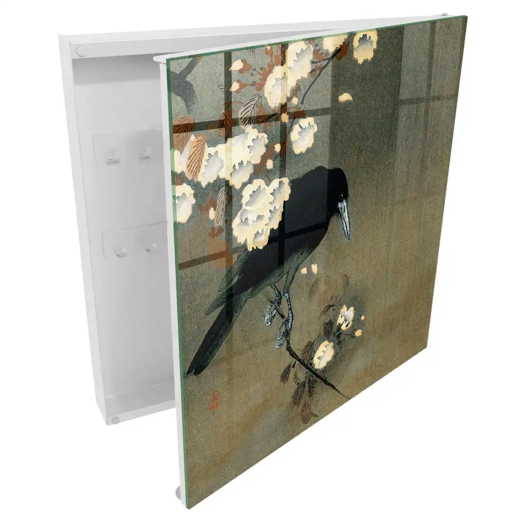 Armoire à clés un corbeau sur une branche avec des fleurs blanches