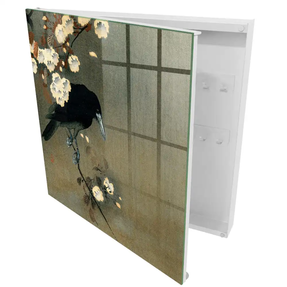 Armoire à clés un corbeau sur une branche avec des fleurs blanches