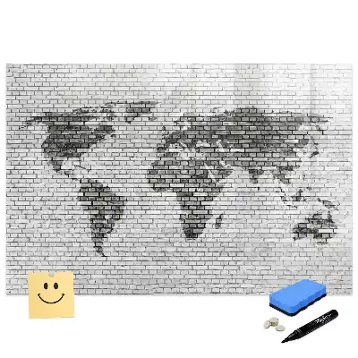 Tableau magnétique illustrant le monde sur fond de mur de briques